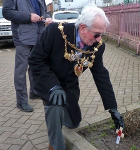 The Mayor of Chorley Cllr Roy Lees leaves a poppy cross outside the station